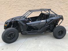 the can - am commander is parked in front of a building