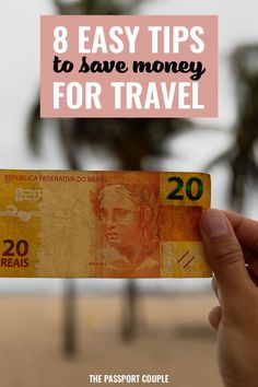 a person holding up a money bill with the words 8 easy tips to save money for travel