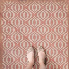 a woman standing on top of a rug with her feet in the middle of it