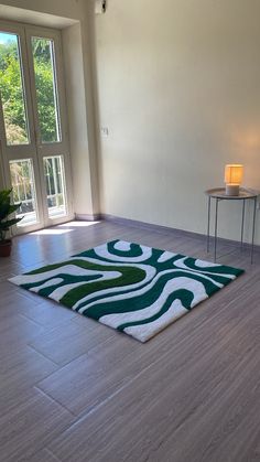 a living room with hard wood flooring and white walls on the windowsills