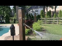 an empty hammock next to a pool in a backyard with a fire hydrant