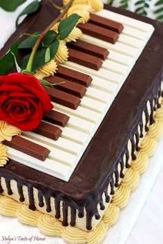 a sheet cake with chocolate icing and a red rose on top