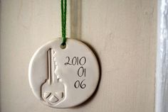 a white ceramic ornament hanging on a wall with the year 2010 written on it