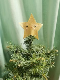 a gold star decoration on top of a christmas tree