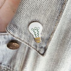 a person wearing a button with a light bulb on it