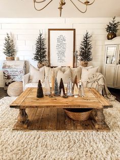 a living room filled with lots of furniture and christmas trees on top of a coffee table