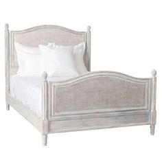 a bed with white linens and pillows on it's headboard, in front of a white background