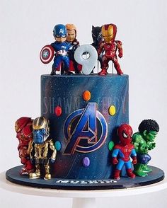 the avengers birthday cake is decorated with figurines on it's tiers