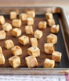 tofu cubes on a baking sheet ready to be cooked in the oven for dinner