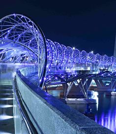 the bridge is lit up with blue lights