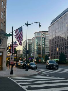 an intersection with cars and buildings in the background