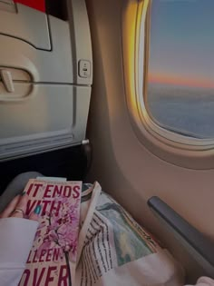 an airplane window with the view of the ocean and land from it's seat