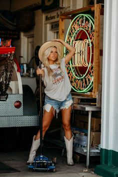 Make America cowboy again with our 1942 America Cowboy Graphic Tee! A classic graphic tee featuring a roping cowboy with an American flag background to spice up your tee collection. Pair with cute denim shorts and boots for a fun western look! Cow Girl Boots With Shorts, Jean Shorts And Cowboy Boots Outfit, Simple Country Outfits, Shorts And Cowboy Boots Outfit, Make America Cowboy Again, Cowboy Clothes, Boho Cowboy, Cowboys Boots, Cute Denim Shorts