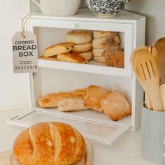 breads and pastries are displayed on shelves in a bakery