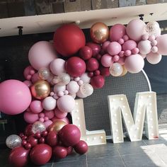 a large balloon wall with the letter m on it