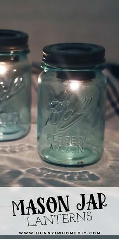 two mason jars sitting on top of a table with the words mason jar lanterns above them