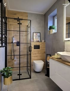 a bathroom with a toilet, sink and shower stall in the middle of the room