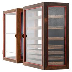 a wooden display case with glass doors on the front and back sides, open to reveal shelves