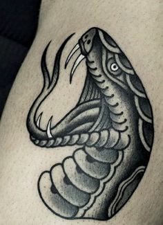 a black and white photo of a snake tattoo