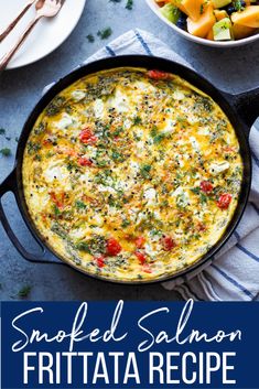 an omelet with spinach, tomatoes and other vegetables in a skillet