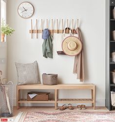 a coat rack with hats, scarves and shoes on it next to a bench