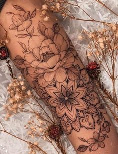 a woman's arm with flowers on it