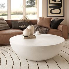 The Lensey Modern Concrete Round Coffee Table features a sleek, minimalistic design with a smooth, rounded form that exudes contemporary elegance. Its all-white or all-black concrete finish offers a striking aesthetic, making it a versatile centerpiece for any living space. The spacious, flat surface is perfect for displaying decor or accommodating drinks and snacks, while the bowl-like shape adds a unique touch to your interior. Orren Ellis Color: White Orren Ellis Lensey Concrete Round Coffee Organic Modern Coffee Table, Black Round Coffee Table, Round Outdoor Coffee Table, Montauk House, White Round Coffee Table, Circle Coffee Tables, Black Concrete, Concrete Coffee Table, Drum Coffee Table