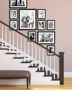 a stair case with many pictures on the wall