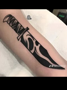 a black and white tattoo with a knife on it