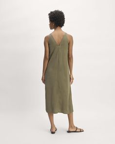 About This Style. This piece features a relaxed fit, midi-length, sleeveless, v-neck in front and back, full lining, slightly fitted waist and side slits. Midi Slip Dress, Maxi Slip Dress, Midi Length, Jumpsuit Dress, Slip Dress, Relaxed Fit, V Neck, Womens Dresses, Dresses