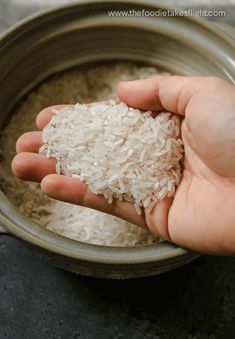 a person is holding rice in a bowl