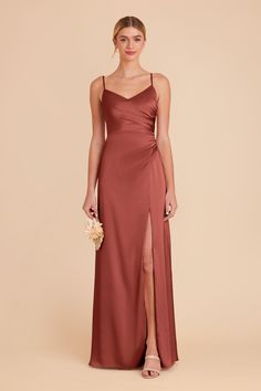 a bridesmaid in a long, spaghetti - neck dress with side slits