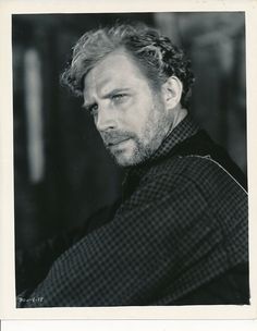 a black and white photo of a man with curly hair