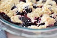 a blueberry cobbler in a glass bowl on a table