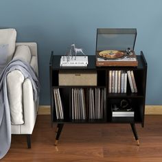 a living room with a couch, table and bookshelf on it's side