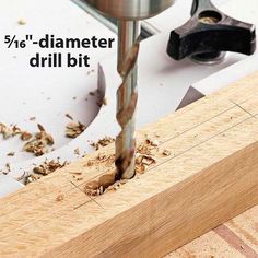 a drill being used to drill holes in wood