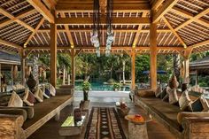 an outdoor living area with couches and tables