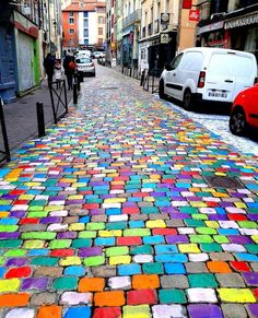 the sidewalk is made out of colored bricks