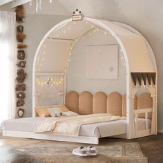 a white bed sitting under a canopy in a bedroom