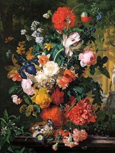 a vase filled with lots of colorful flowers