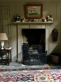 a living room with a fire place and rug on the floor