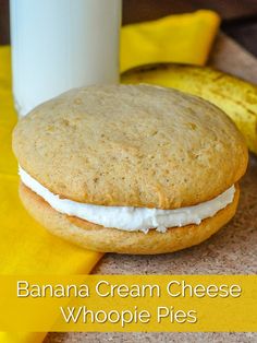 a banana cream cheese whoopie pie next to a glass of milk