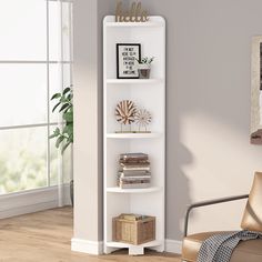 a white book shelf with books on it in a living room next to a window