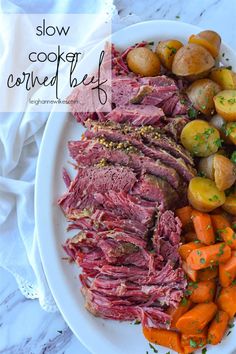 corned beef, potatoes and carrots on a white plate