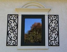 an image of a window that is in the side of a building with trees reflected in it