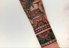 a woman's arm with an ornate tattoo design on the left side of her arm