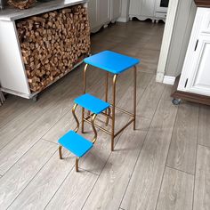 two blue stools sitting on top of a wooden floor