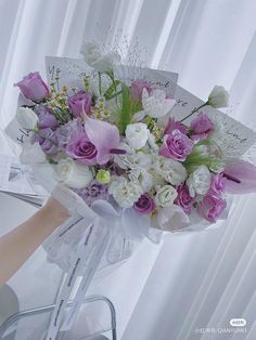 a bouquet of flowers sitting on top of a chair