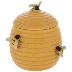 a yellow beehive with two bees sitting on it's sides and the top