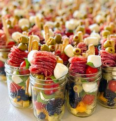 many small jars filled with different types of food